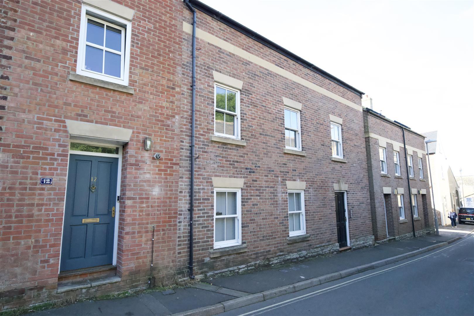 Traditional brick townhouse street view listed by ColmerTominey