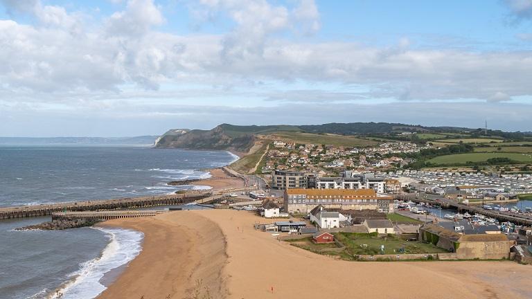 Scenic coastal view of West Bay beach and harbor near Bridport Dorset
